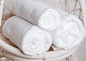 Image shows some towels rolled ready to use